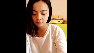 Young Asian teen showcasing her smooth body